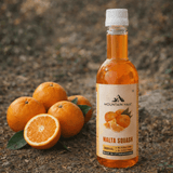 Malta Squash bottle placed with fresh Himalayan malta fruit outdoors